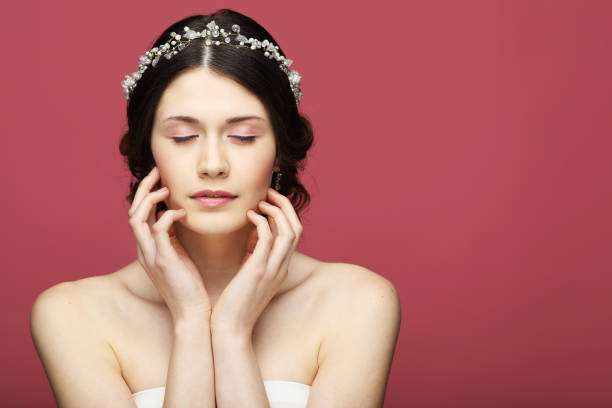 Jewelry, luxury, wedding and people concept: young bride with gorgeous diadem in her hair stock photo