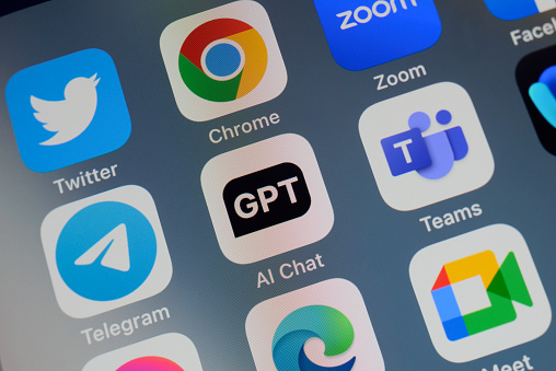 Close-up of of the icon of the ChatGPT artificial intelligence chatbot app logo on a cellphone screen. Surrounded by the app icons of Twitter, Chrome, Zoom, Telegram, Teams, Edge and Meet.