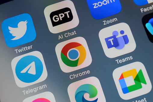 Close-up of of the icon of the Google Chrome artificial intelligence Internet browser app logo on a cellphone screen. Surrounded by the app icons of Twitter, ChatGPT, Zoom, Telegram, Teams, Edge and Meet.