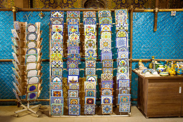 Esfahan, Iran - 15th may, 2022: handmade iranian tile souvenirs stand with beautiful design tiles for gift to buy in Isfahan square Esfahan, Iran - 15th may, 2022: handmade iranian tile souvenirs stand with beautiful design tiles for gift to buy in Isfahan square persian pottery stock pictures, royalty-free photos & images