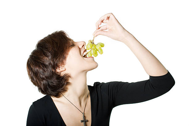 Girl with grapes stock photo