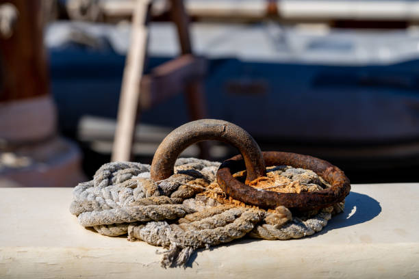 Closeup shows the texture of the rings and rope rigging on a sailboat.
