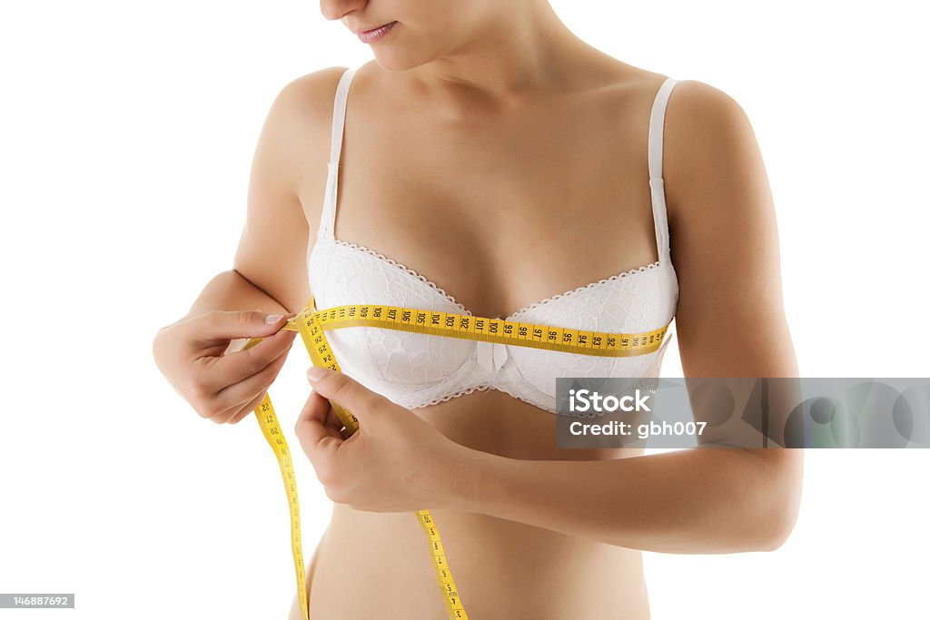 Kobieta pomiaru jej ciało na białym tle - Zbiór zdjęć royalty-free (20-24 lata)