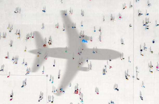 istock Aerial view of crowd with airplane shadow 1468878721