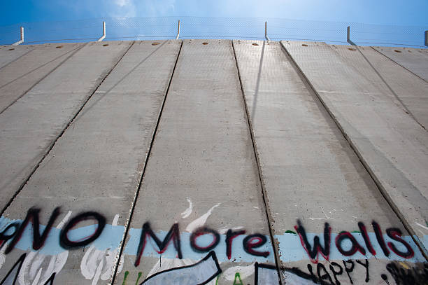 Israeli Separation Barrier BETHLEHEM, OCCUPIED PALESTINIAN TERRITORIES - Activist graffiti adorns the Israeli separation wall in the West Bank town of Bethlehem. segregation stock pictures, royalty-free photos & images