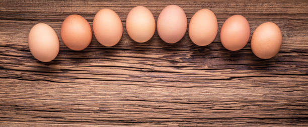 istock Farm-fresh brown eggs on weathered board 1468882033