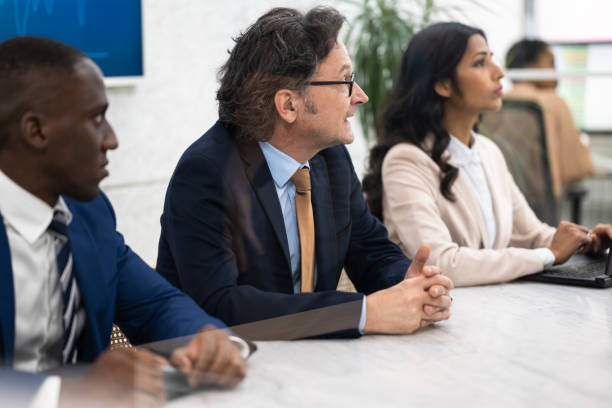 istock Diverse Corporate Employees Sitting At Conference Room Table 1468883113