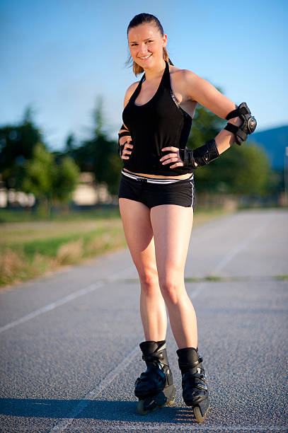 istock Young girl with rollerblades poses on track 146888415