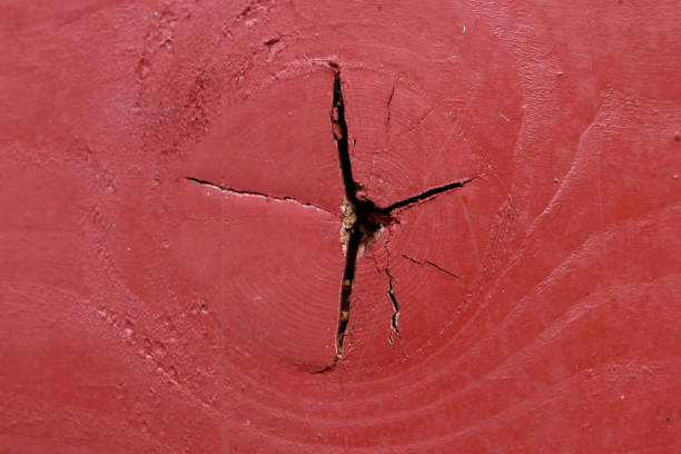 the texture of a red-colored cracked wooden table.