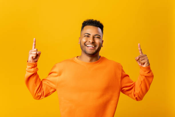 istock Attractive man with happy facial expression pointing up with both fingers 1468888246