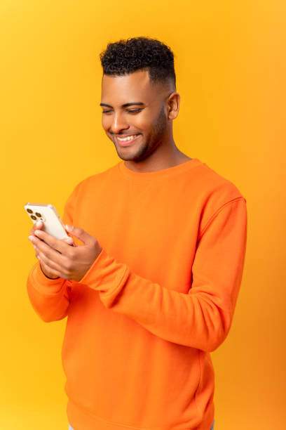 istock Optimistic hindu man wearing casual clothes texting on the smartphone, messaging, smiling guy enjoying using new mobile app 1468888645