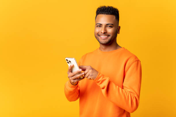 istock Optimistic hindu man wearing casual clothes texting on the smartphone, messaging, smiling guy enjoying using new mobile app 1468888658