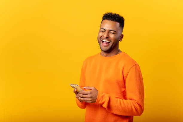istock Optimistic indian man texting on the smartphone and laughing, smiling guy enjoying using new mobile app isolated 1468888903