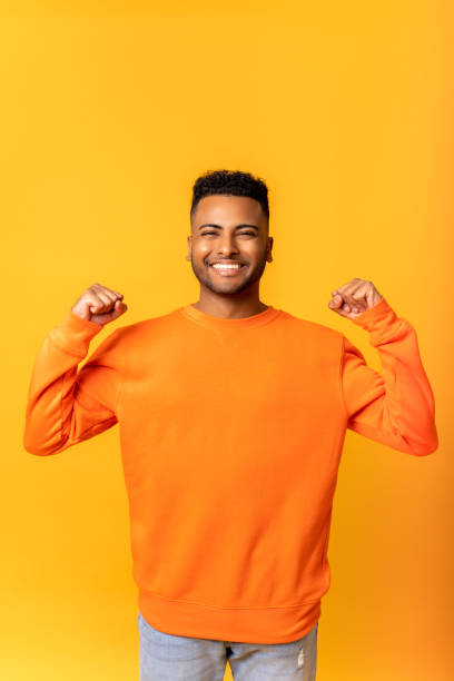 istock Extremely excited overjoyed man shouting making yes gesture, amazed with his victory, triumph. Indoor studio shot isolated on yellow 1468889050