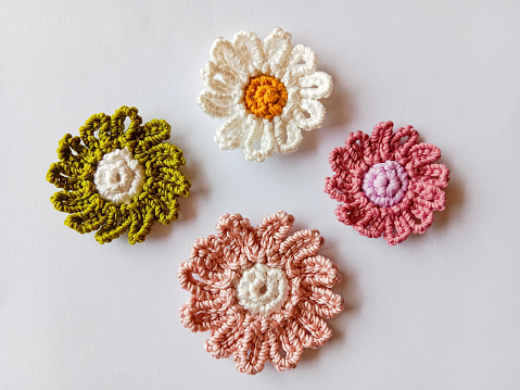 Crochet flower. Crochet flower isolated on white background. Crochet of daisy flower. Knitted flower. Top view.