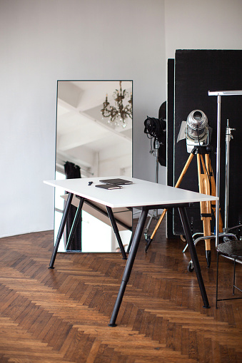 The interior of the creative workshop. Table and mirror. Photo studio equipment.