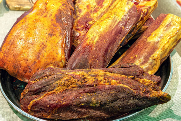 istock Whole pieces of jerky pork ham on dish, top view. 1468892747