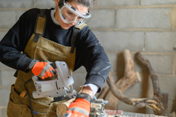 istock Female carpenter sanding a piece of wood in a workshop 1468892941