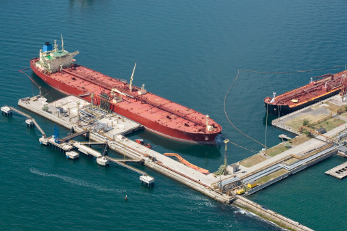 The tanker standing at the oil terminal, against the sea a sunny day It is taken out from the helicopter.