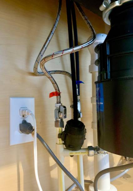 istock Hot and cold water connection under residential kitchen sink 1468899449