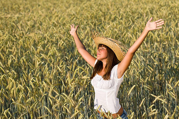istock Happy woman with straw hat enjoy sun in corn field 146890031
