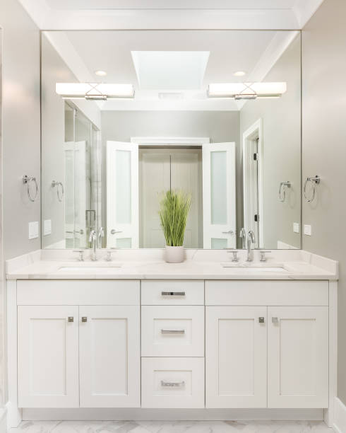 istock A modern bathroom with a white cabinet and lights mounted on the mirror. 1468900754