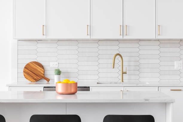 istock A white kitchen detail with bar stools sitting at an island. 1468900757