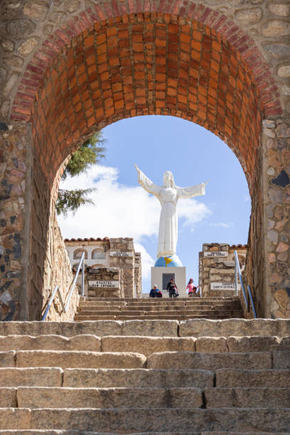 the campo santo cemetery, in the background the monumental christ and some tourists going down the stairs in yungay, ancash, peru - july 2022 - rocio monasterio imagens e fotografias de stock