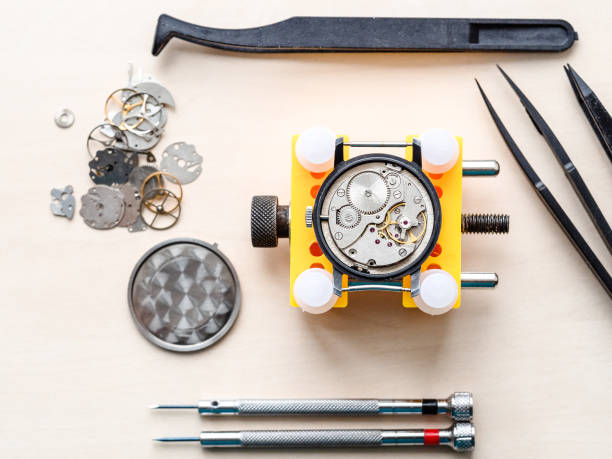 top view of open watch in yellow holder and tools stock photo