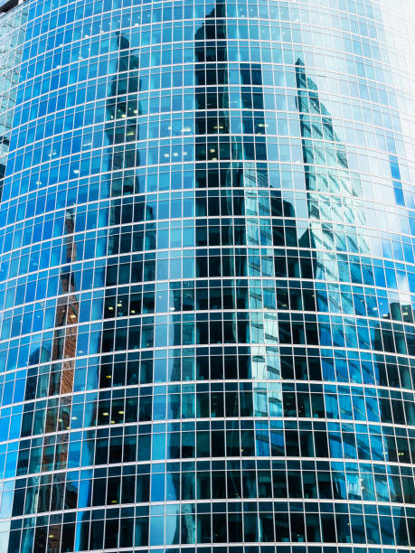 istock front view of glass tower facade with reflection 1468902666