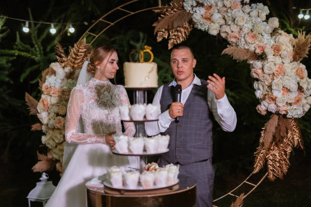 istock newlyweds happily cut and taste the wedding cake 1468903546