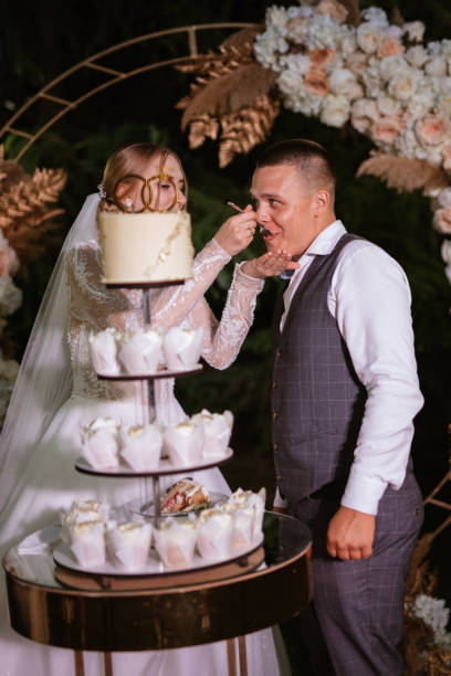 istock newlyweds happily cut and taste the wedding cake 1468904338