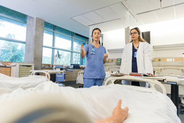 istock Nurse stands bedside to give the doctor an update 1468904886