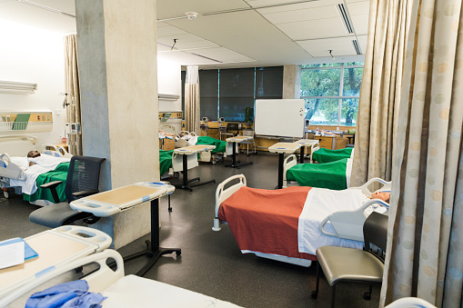 A photo of mannequins in hospital beds at the medical building training classroom.