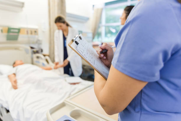 istock Unrecognizeable nurse stands and takes notes in the medical classroom 1468904902