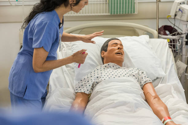 istock Female nurse uses a flashlight to practice checking vitals on a patient 1468905121