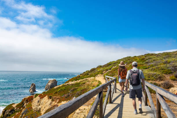 Couple hiking on vacation by the ocean.