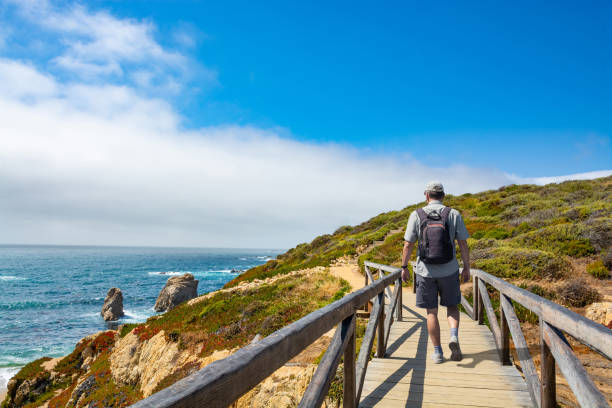 istock Man hiking alone  along the coast on vacation. 1468907083
