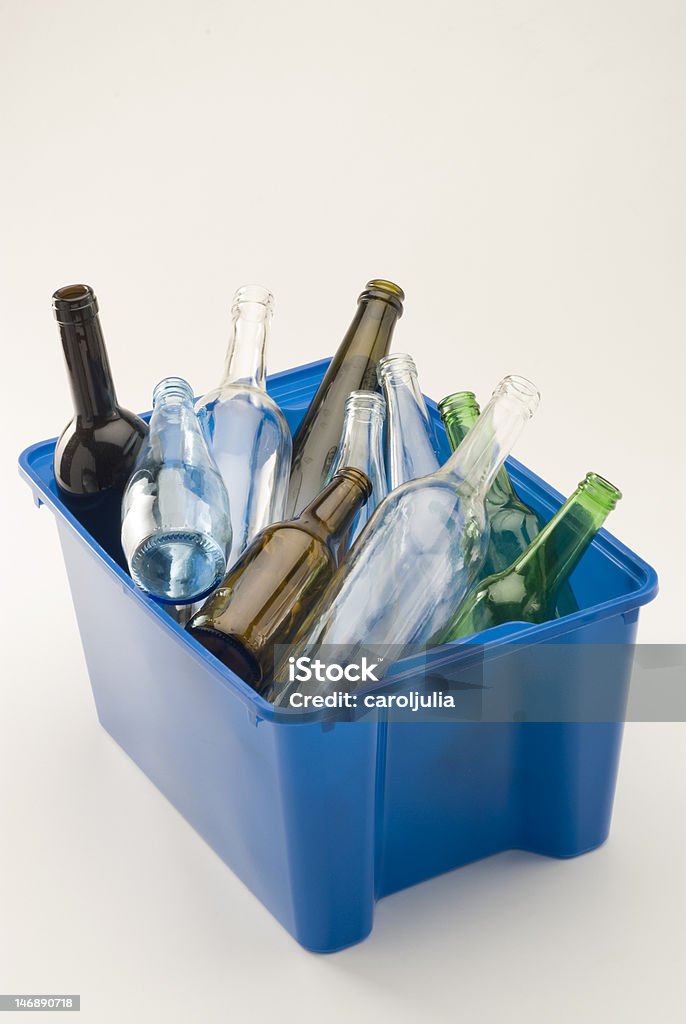 Recycling Glass bottles in a blue recycling bin. White background. Bottle Stock Photo