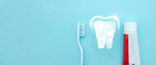 istock Close up of a toothbrush and toothpaste with thin linear Low poly tooth icon on blurred blue background. Oral Dentist stomatology medical concept. 1468911651