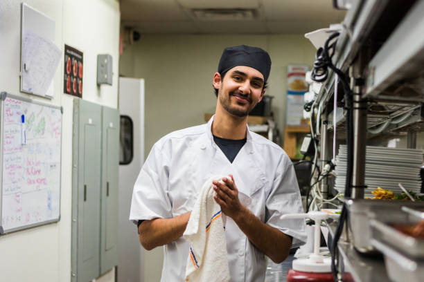 istock Cheerful male chef cleans up kitchen after long day 1468911896