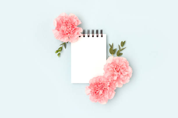 istock Blank notepad mockup, pink carnation flowers and green eucalyptus branches. 1468912590