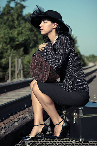 istock Woman Sitting and Waiting at Train Tracks 146891293