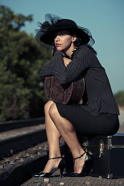 istock Woman Sitting and Waiting at Train Tracks 146891294