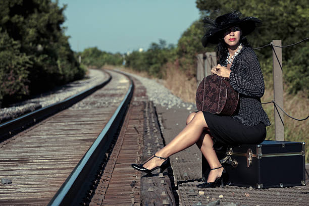 istock Woman Sitting and Waiting at Train Tracks 146891295