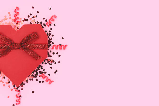 istock Gift box in a heart shape tied with glittering ribbon. 1468915622