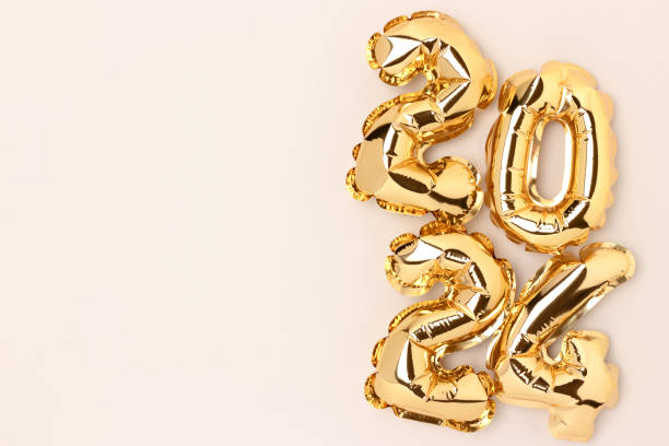 istock 2024 gold colored shiny foil balloons on a gray background with copy space. 1468915748