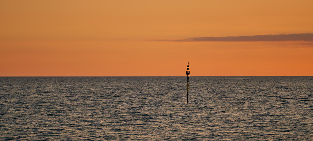 panoramic view of the sea with metal pole and nice sunset