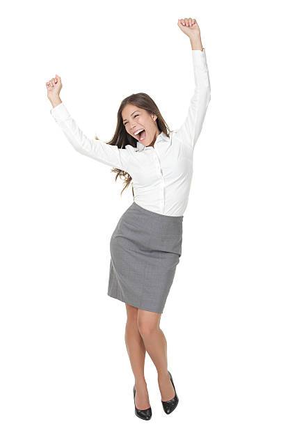 Success business woman celebrating Success woman celebrating in winner dance. Casual young successful businesswoman dancing very happy. Full length Isolated on white background. Click for more: arms raised women business full length stock pictures, royalty-free photos & images