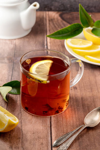 istock Black tea in glass cup on wooden table 1468917222